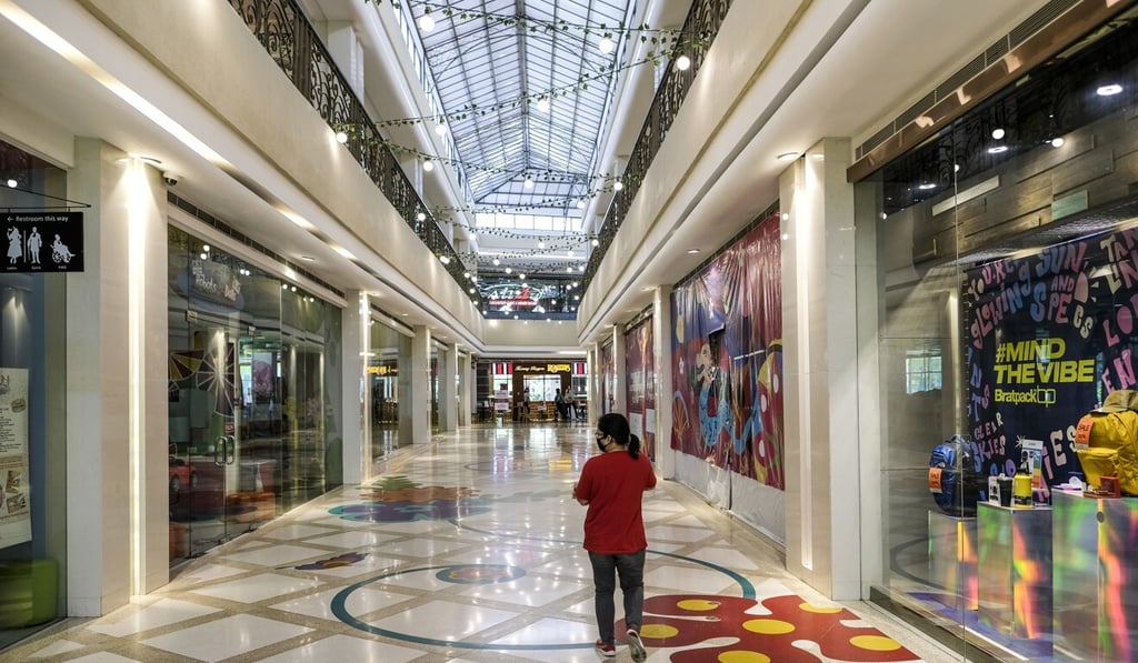 A lone customer walks through the Venice Grand Canal Mall in Taguig City, Metro Manila, in June. Photo: Bloomberg A lone customer walks through the Venice Grand Canal Mall in Taguig City, Metro Manila, in June. Photo: Bloomberg
