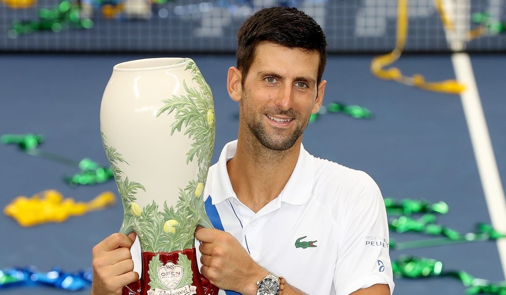 Novak Djokovic poses with the winner's trophy after defeating Milos Raonic of Canada in the men's singles final of the Western & Southern Open. Photo: AFP