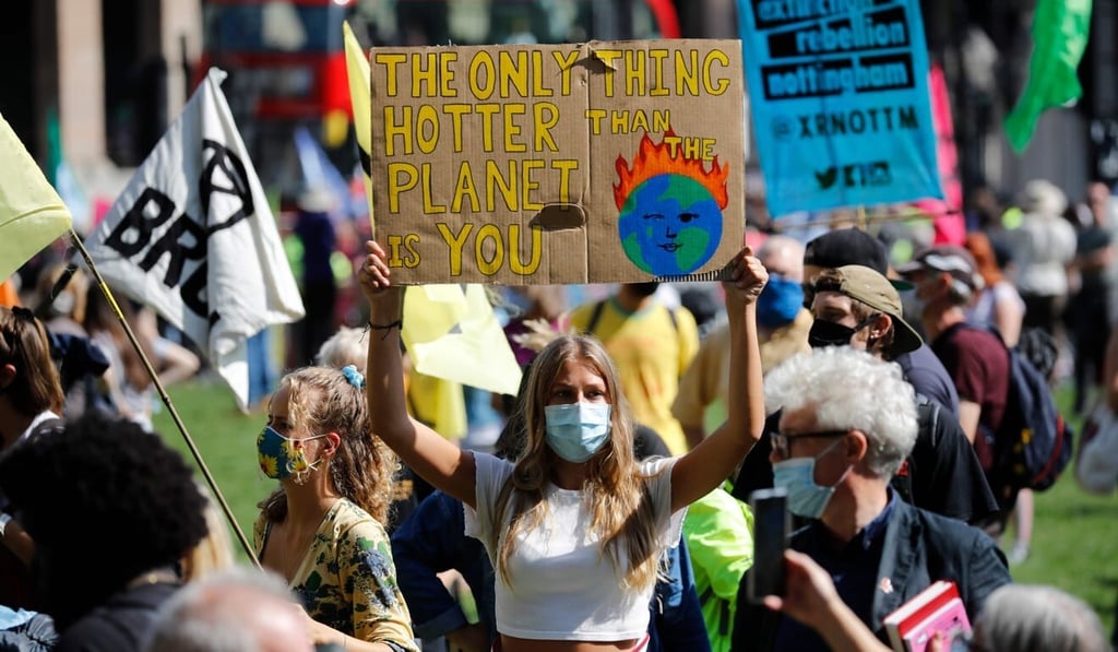 Activists from the climate protest group Extinction Rebellion march with placards in the British capital on Tuesday. Photo: AFP