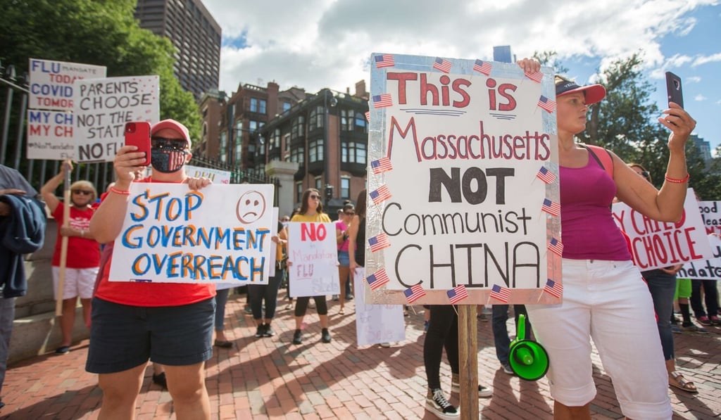 Anti-vaccine activists hold signs at a protest outside the Massachusetts State House on August 29. Photo: AFP Anti-vaccine activists hold signs at a protest outside the Massachusetts State House on August 29. Photo: AFP