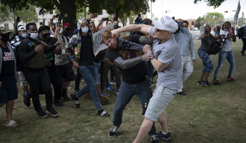 A scuffle between protesters and supporters of US President Donald Trump in downtown Kenosha, Wisconsin, after Trump's visit. Photo: TNS