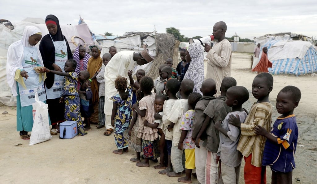 Health officials administer polio vaccines to children at a camp for displaced people in Nigeria, in this 2016 file photo. Photo: AP