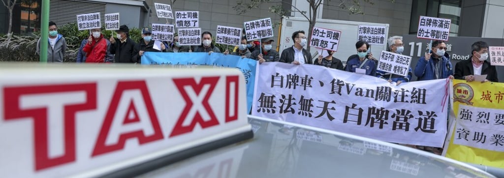 Taxi drivers hold up banners pointing to Uber’s illegal status in Hong Kong at a demonstration outside the West Kowloon Government Offices in Yau Ma Tei in February. Photo: Winson Wong Taxi drivers hold up banners pointing to Uber’s illegal status in Hong Kong at a demonstration outside the West Kowloon Government Offices in Yau Ma Tei in February. Photo: Winson Wong