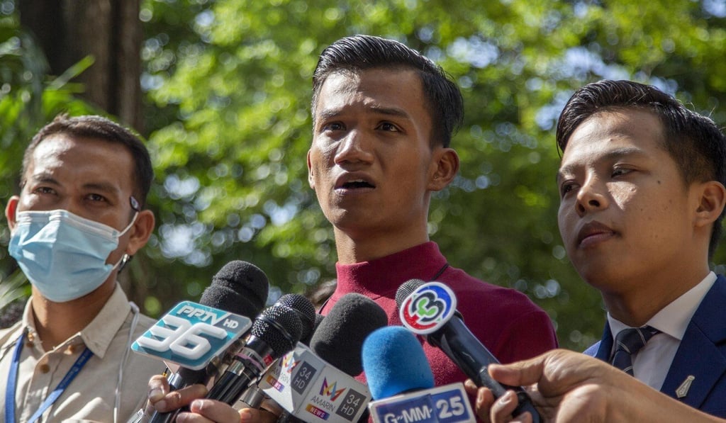 Pro-democracy activist Panupong Jadnok, also known as Mike Rayong, (centre) speaks as he arrives at a courthouse on Thursday to hear whether he has violated his bail conditions. Photo: AP