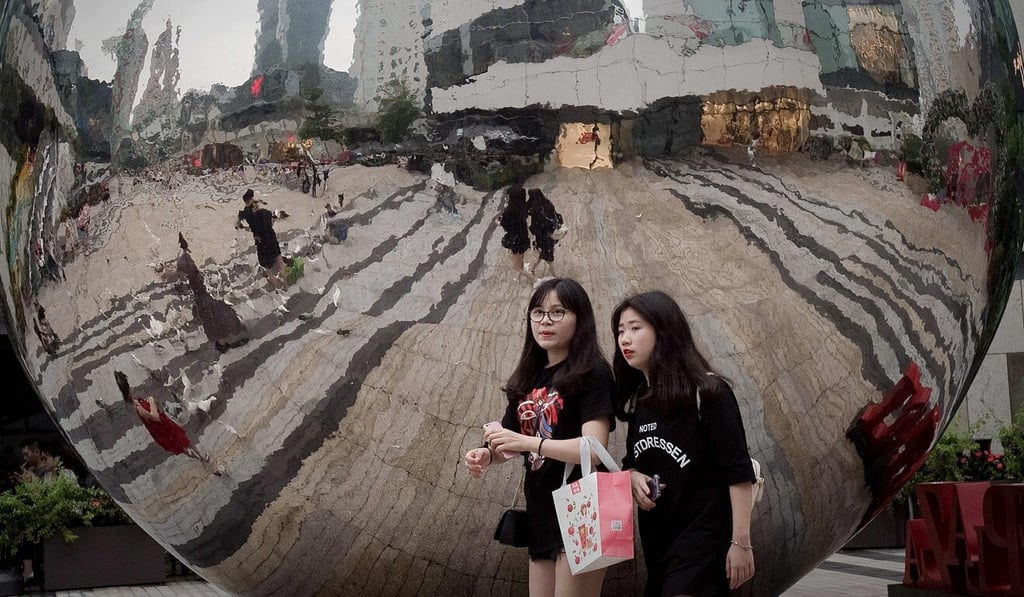 Pedestrians walk through a mall in Shenzhen in May 2017. The city recently announced guidelines for personal bankruptcy. Photo: AFP Pedestrians walk through a mall in Shenzhen in May 2017. The city recently announced guidelines for personal bankruptcy. Photo: AFP