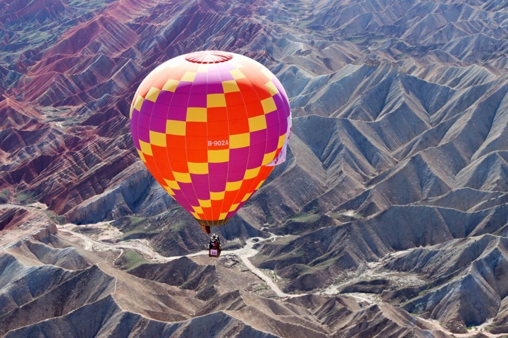 A hot-air balloon floats over Danxia National Geological Park in Zhangye in China’s Gansu province. Photo: Xinhua