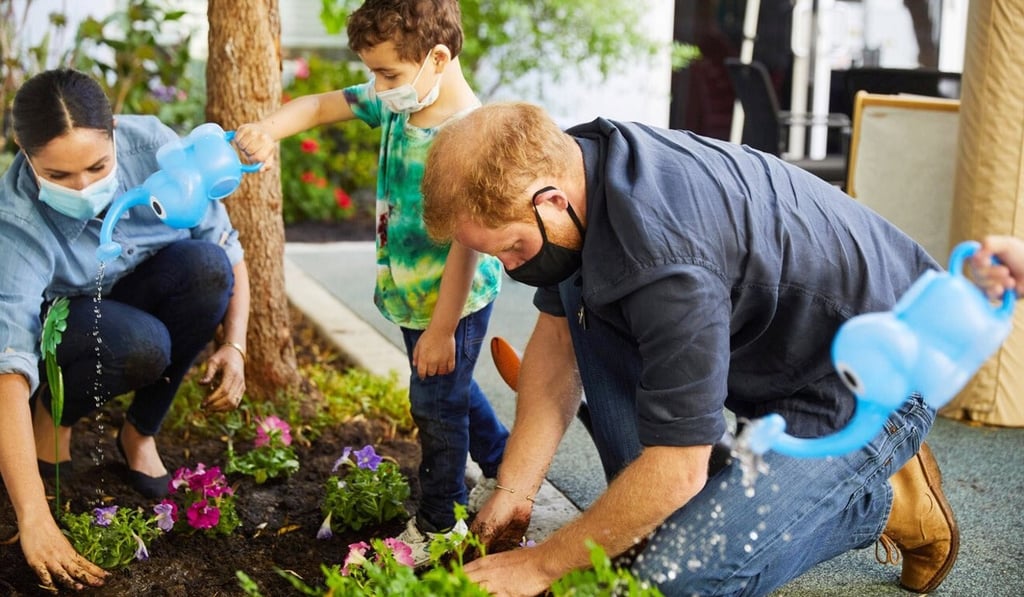 Prince Harry and Meghan Markle plant flowers during a visit to the Assistance League Los Angeles’ Preschool Learning Centre in Los Angeles on Monday. Photo: Matt Sayles via Reuters Prince Harry and Meghan Markle plant flowers during a visit to the Assistance League Los Angeles’ Preschool Learning Centre in Los Angeles on Monday. Photo: Matt Sayles via Reuters