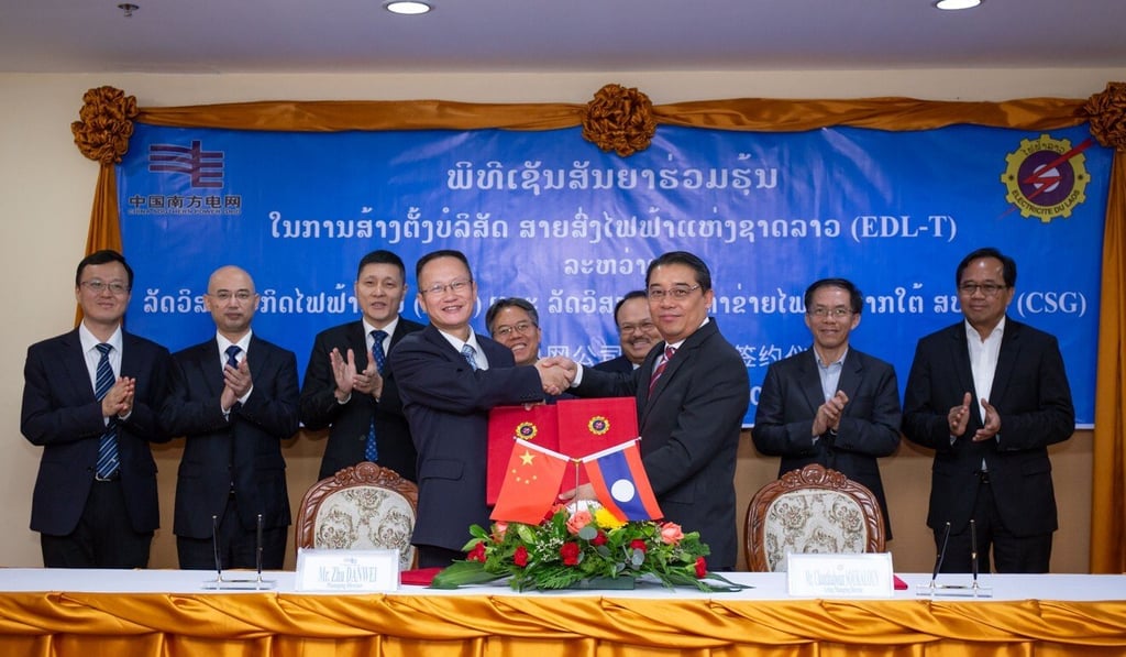 Representatives from China Southern Power Grid and Electricite du Laos shake hands during a signing ceremony in Vientiane, Laos, on Tuesday. Photo: Xinhua Representatives from China Southern Power Grid and Electricite du Laos shake hands during a signing ceremony in Vientiane, Laos, on Tuesday. Photo: Xinhua