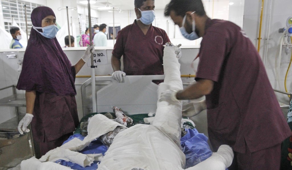 Doctors treat a man who was injured in a gas blast at a mosque outside the capital Dhaka. Photo: AP Doctors treat a man who was injured in a gas blast at a mosque outside the capital Dhaka. Photo: AP