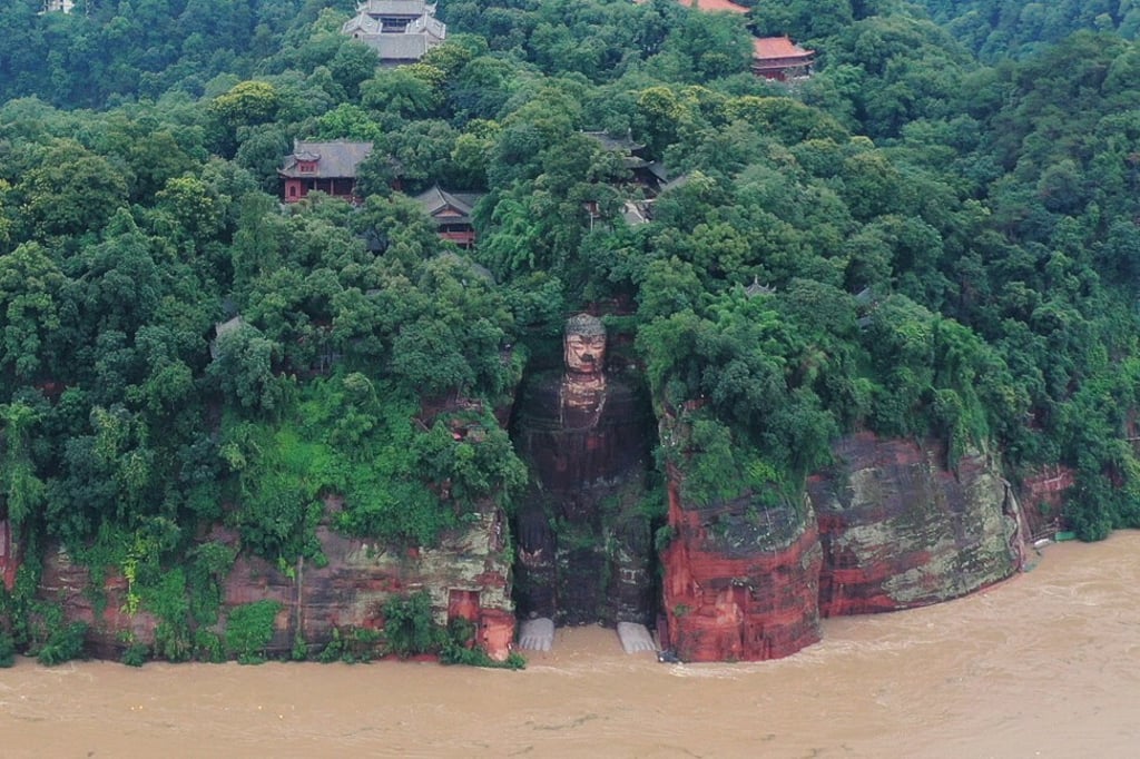 Floodwater reaches the Leshan Giant Buddha’s feet following heavy rainfall in Leshan, Sichuan province, in China. Photo: China Daily via Reuters Floodwater reaches the Leshan Giant Buddha’s feet following heavy rainfall in Leshan, Sichuan province, in China. Photo: China Daily via Reuters