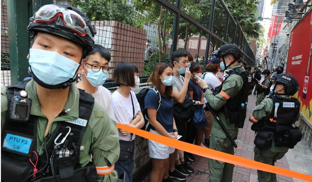 Police officers stop and search people in Mong Kok. Photo: May Tse