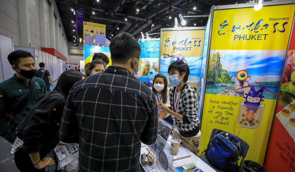 Tour operators for Phuket show options to customers at a domestic travel fair in Bangkok. Photo: EPA