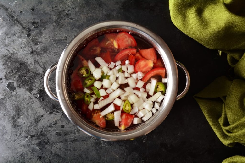 Rasam is traditionally prepared with tamarind water and black pepper, but can also include hot peppers, onions and tomatoes. Photo: Shutterstock