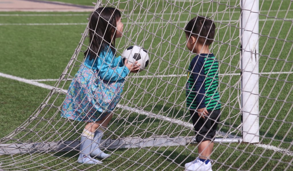 Children play football on artificial turf at Happy Valley Recreation Ground in January 2017. Photo: David Wong