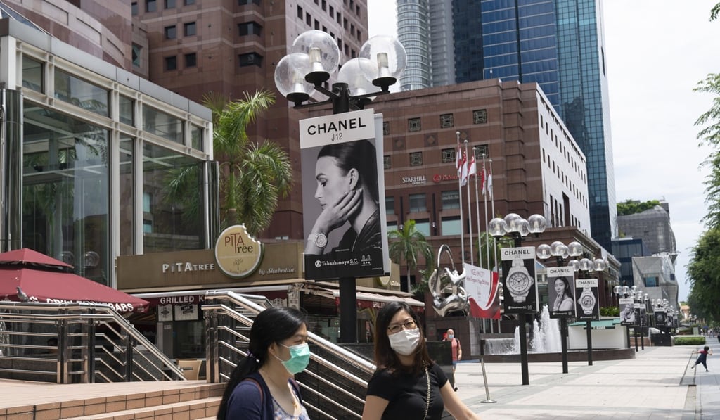 Pedestrians in Singapore’s shopping and commercial centre of Orchard Road. Photo: Bloomberg Pedestrians in Singapore’s shopping and commercial centre of Orchard Road. Photo: Bloomberg