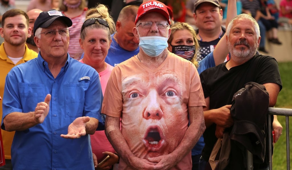 Supporters, one wearing a shirt with US President Donald Trump's face on it, attend a campaign event in North Carolina on Tuesday. Photo: Reuters