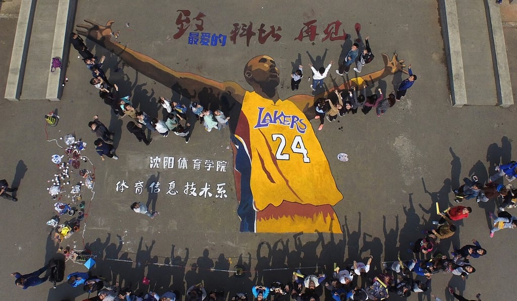 A group of students pose with a mural of Los Angeles Lakers legend Kobe Bryant at Shenyang Sport University, Lianing province in 2016. Photo: Xinhua A group of students pose with a mural of Los Angeles Lakers legend Kobe Bryant at Shenyang Sport University, Lianing province in 2016. Photo: Xinhua
