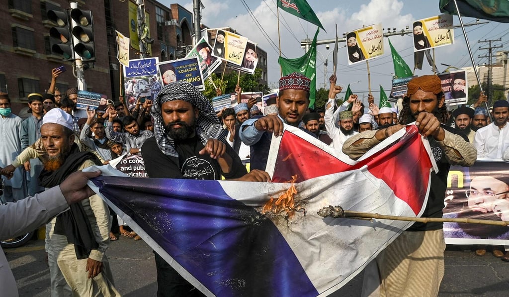 Protesters in Lahore, Pakistan, burn a representation of the French flag during a rally to condemn Charlie Hebdo for republishing caricatures of the Prophet Mohammed. Photo: AP Protesters in Lahore, Pakistan, burn a representation of the French flag during a rally to condemn Charlie Hebdo for republishing caricatures of the Prophet Mohammed. Photo: AP