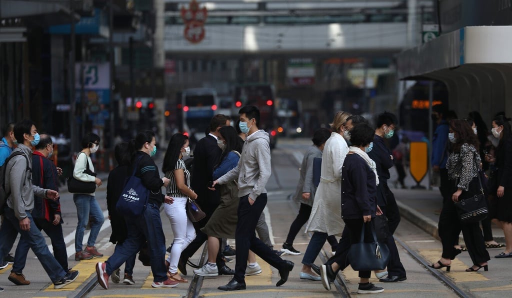 Office workers cross a busy street in Central, Hong Kong, on April 15. Many companies have shifted to work-from-home arrangements to help contain the spread of the coronavirus, dealing a blow to office leasing activity. Photo: Nora Tam