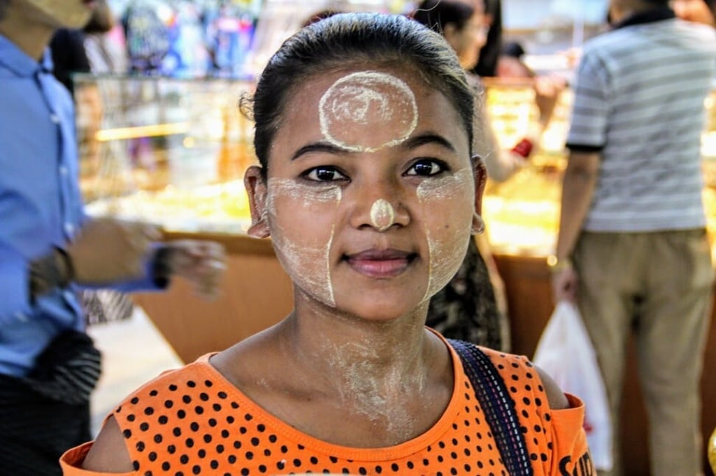 A woman in Myanmar wearing thanaka paste as sunscreen. Photo: Kalpana Sunder