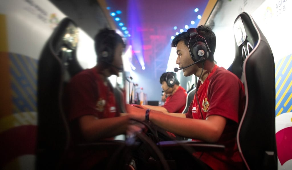 An e-sports player sits in a typical gaming chair during the 2018 Asian Games in Jakarta, Indonesia. E-sports was an exhibition sport during the event, ahead of its entry as a medal event at the next Asian Games in China in 2022. Photo: AFP