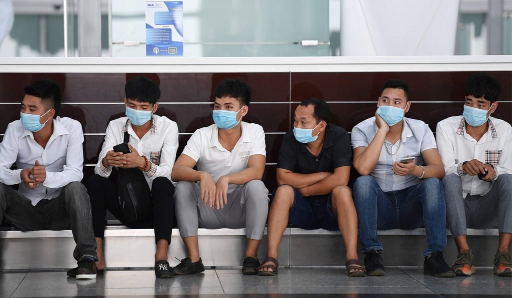 People wait inside the departure terminal at Noi Bai International Airport in Hanoi on Wednesday. Photo: AFP