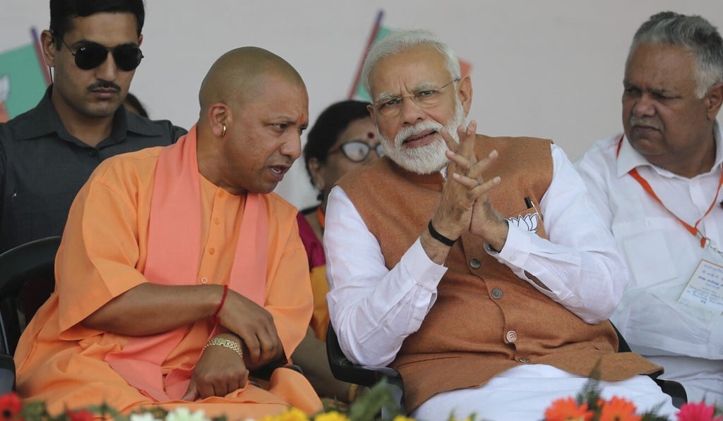 Yogi Adityanath pictured speaking with Modi in March 2019. Photo: AP