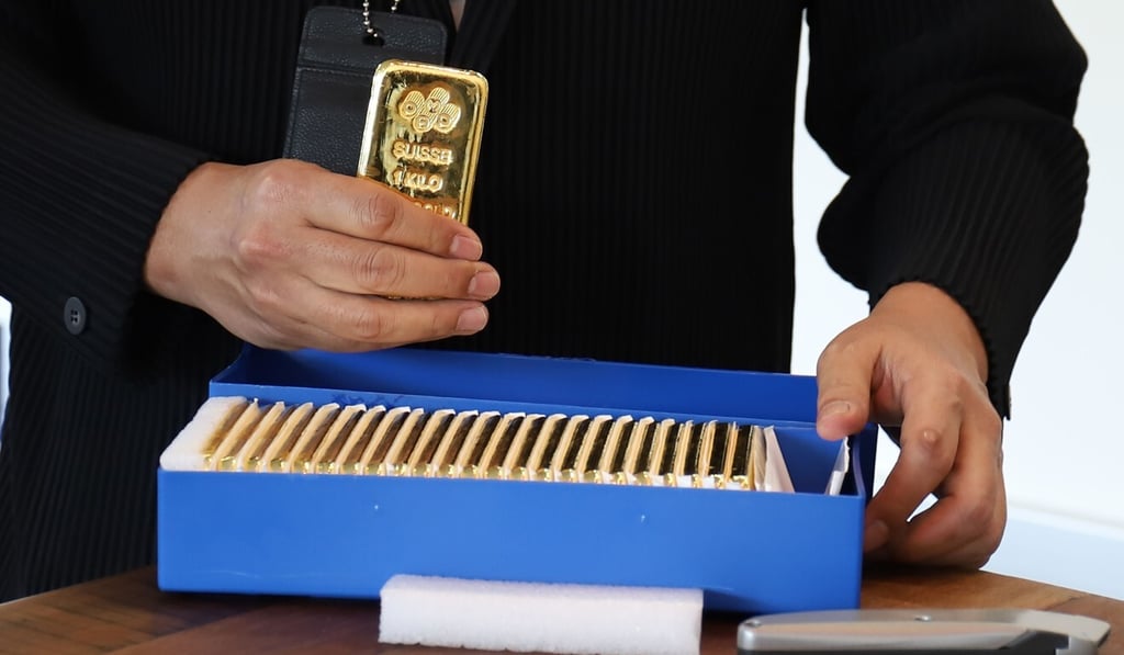 Victor Foo, CEOof the Singapore Precious Metals Exchange displays 1kg gold bars at his office in Le Freeport. Photo: AFP