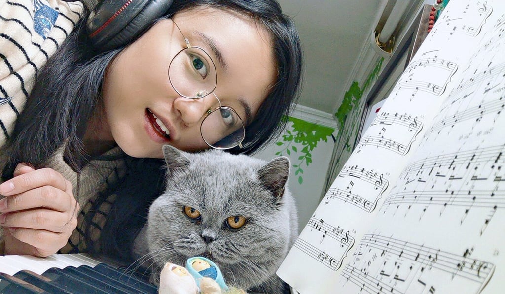Piano teacher Mary Zhu with one of her pet cats. Photo: Handout Piano teacher Mary Zhu with one of her pet cats. Photo: Handout