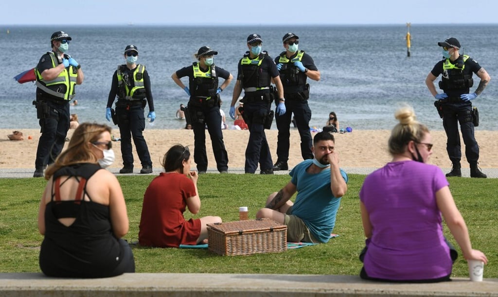 Police patrol a beach in Melbourne to enforce coronavirus rules. Photo: AFP