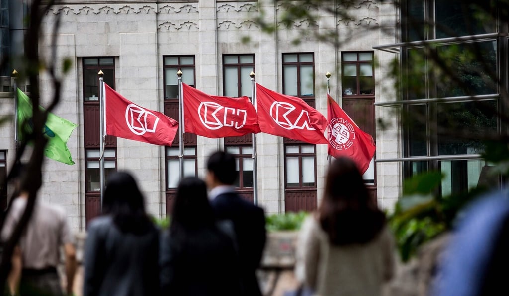People walk past flags of CK Hutchison Holdings and CK Asset outside the company’s headquarters in Hong Kong. Photo: AFP People walk past flags of CK Hutchison Holdings and CK Asset outside the company’s headquarters in Hong Kong. Photo: AFP