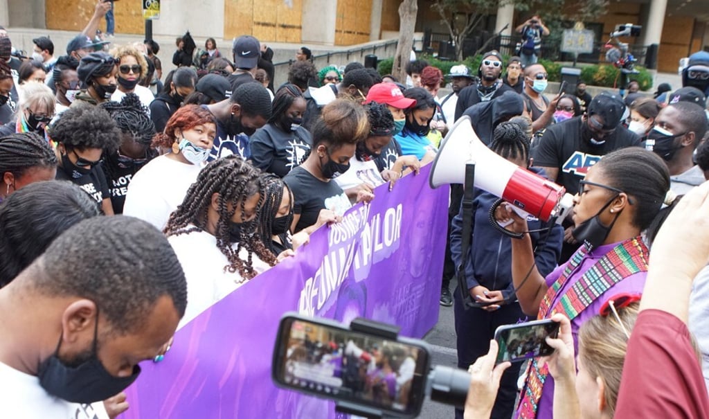 Breonna Taylor's mother Tamika Palmer uses a loud hailer during a march with protesters in Louisville on September 25, 2020. Photo: Reuters