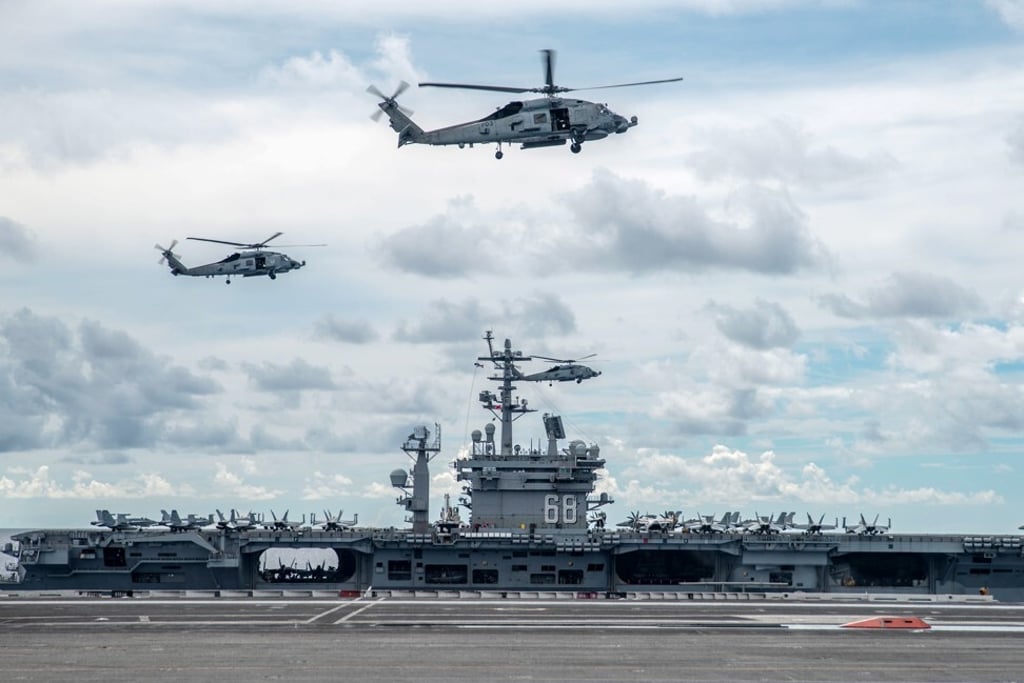 Two MH-60R Sea Hawks hover over the USS Ronald Reagan during a drill in the South China Sea. Photo: EPA-EFE