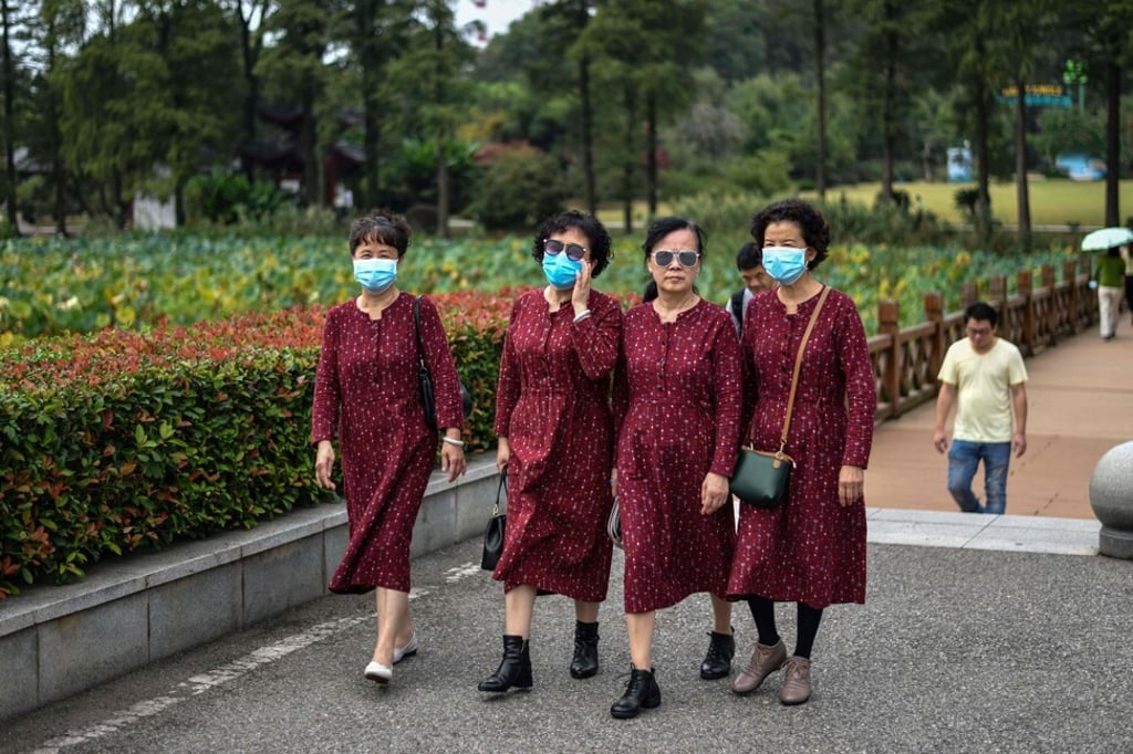 Women wearing face masks visit the Moshan Scenic Area near East Lake in Wuhan. Photo: AFP