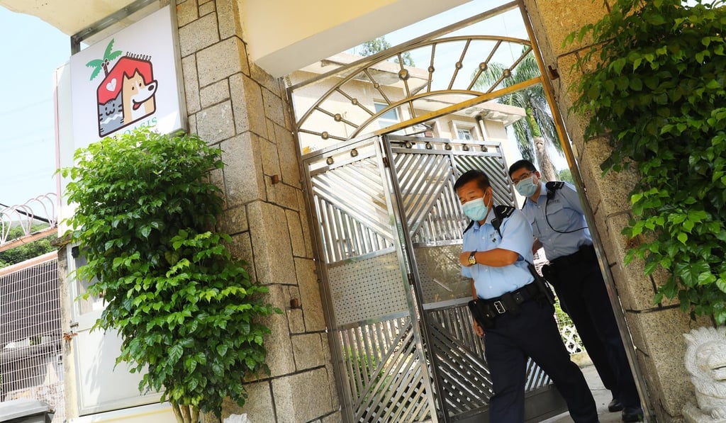 Police officers leave the Pet Oasis in Tuen Mun after rescuing 48 cats and dogs believed to be destined for mainland China. Photo: Dickson Lee Police officers leave the Pet Oasis in Tuen Mun after rescuing 48 cats and dogs believed to be destined for mainland China. Photo: Dickson Lee