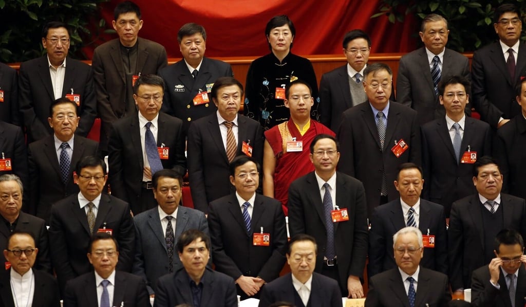 Gyaincain Norbu stands with other CPPCC delegates as they listen to the national anthem at the Great Hall of the People in Beijing in 2014. Photo: Reuters Gyaincain Norbu stands with other CPPCC delegates as they listen to the national anthem at the Great Hall of the People in Beijing in 2014. Photo: Reuters