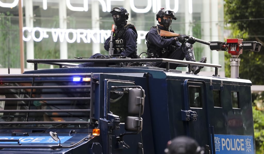 Police officers monitor the crowd from the top of an armoured vehicle during an illegal demonstration on July 1. Photo: Dickson Lee Police officers monitor the crowd from the top of an armoured vehicle during an illegal demonstration on July 1. Photo: Dickson Lee