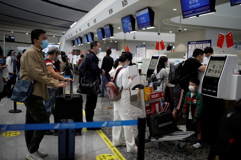 Passengers wearing face masks line up to check in at the Beijing Daxing International Airport on September 25 ahead of the Chinese National Day holiday. Photo: Reuters Passengers wearing face masks line up to check in at the Beijing Daxing International Airport on September 25 ahead of the Chinese National Day holiday. Photo: Reuters