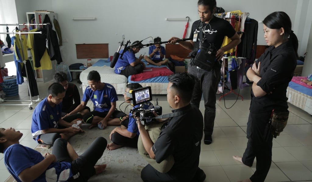 Eye on the Ball director Yihwen Chen (right) overseeing filming with the blind football team. Photo: Handout