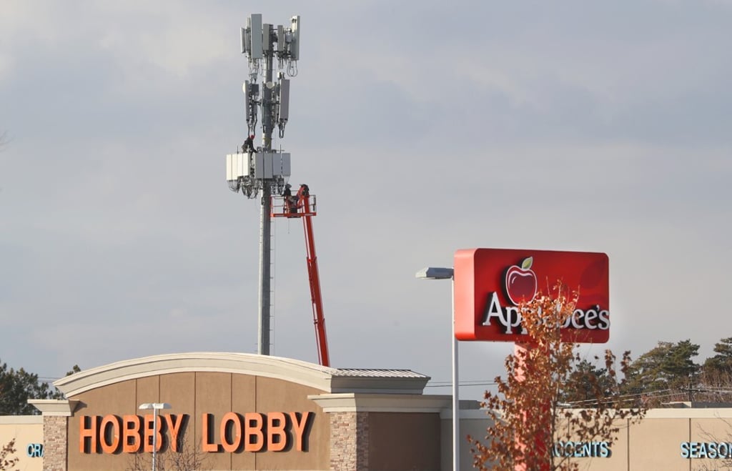 Workers rebuild a cellular tower with 5G equipment for the Verizon network in the US state of Utah. Photo: George Frey/Getty Images Workers rebuild a cellular tower with 5G equipment for the Verizon network in the US state of Utah. Photo: George Frey/Getty Images