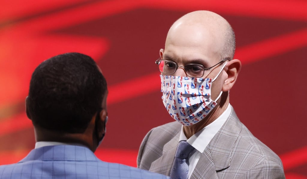 Silver speaks to someone while wearing a mask before the start of the NBA Finals basketball game two between the Miami Heat and the Los Angeles Lakers. Photo: EPA