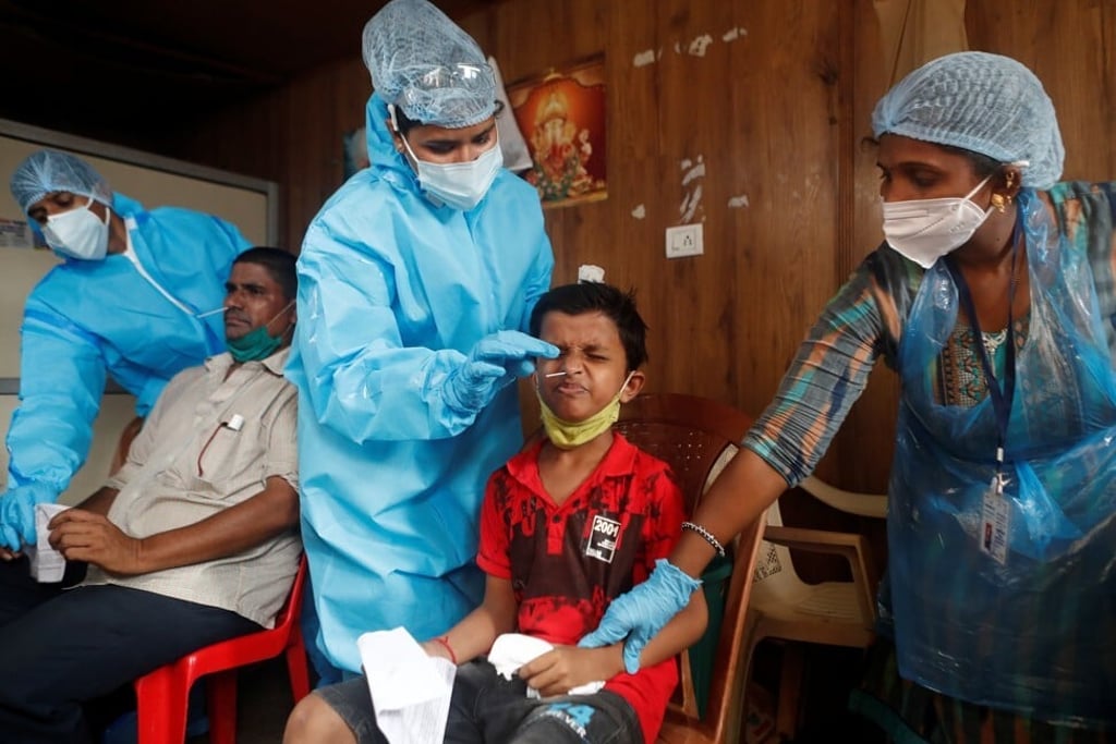Health workers collect swab samples from villagers on the outskirts of Mumbai. Photo: Reuters Health workers collect swab samples from villagers on the outskirts of Mumbai. Photo: Reuters