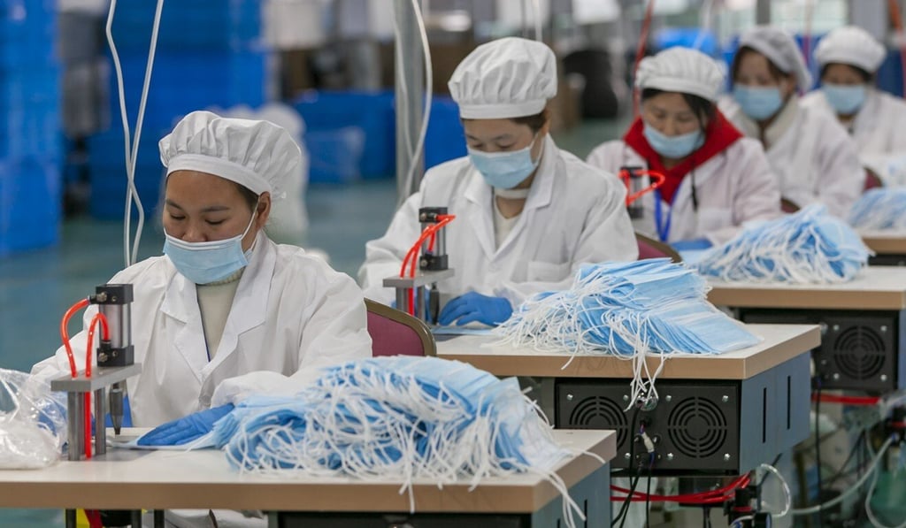 Workers make protective masks at a factory in Shanghai. Beijing’s diplomats have touted China’s donations of PPE and its containment of the virus. Photo: Xinhua
