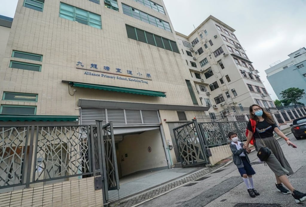 A student and his mother at Alliance Primary School in Kowloon Tong, where the disqualified had worked. Photo: Felix Wong A student and his mother at Alliance Primary School in Kowloon Tong, where the disqualified had worked. Photo: Felix Wong
