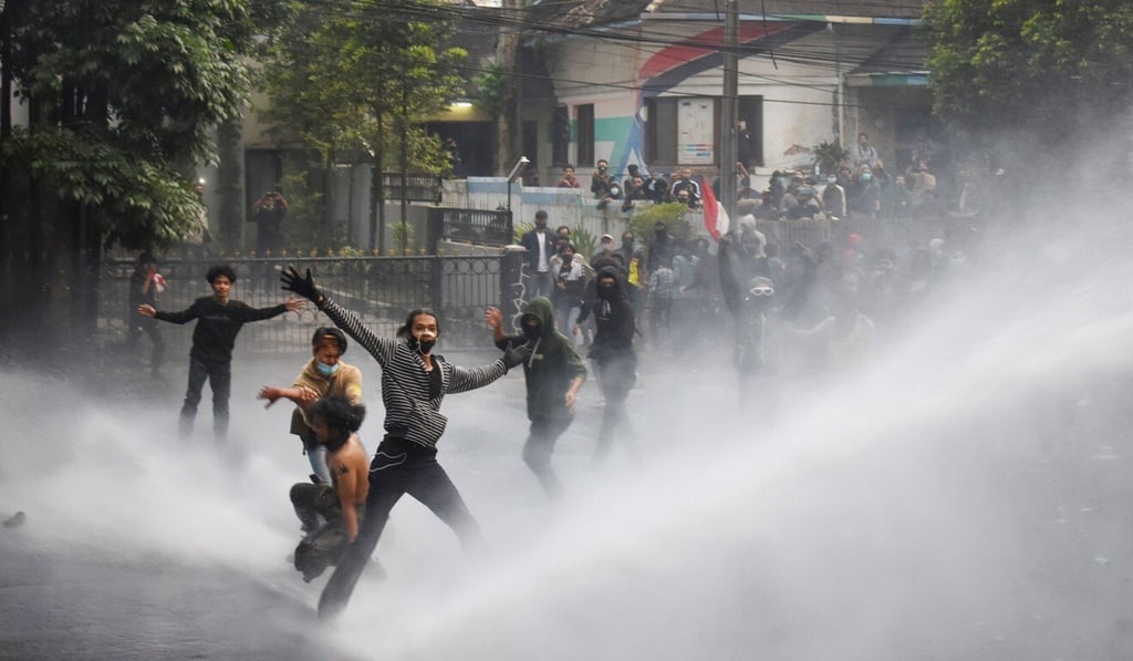 Riot police unleash water cannon to disperse student protesters in Bandung. Photo: AFP Riot police unleash water cannon to disperse student protesters in Bandung. Photo: AFP