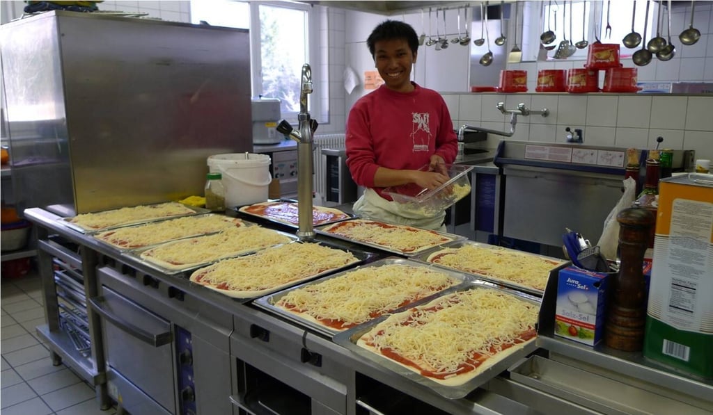 Wilson Cheung working as a mountain hut keeper, preparing foods for guests.