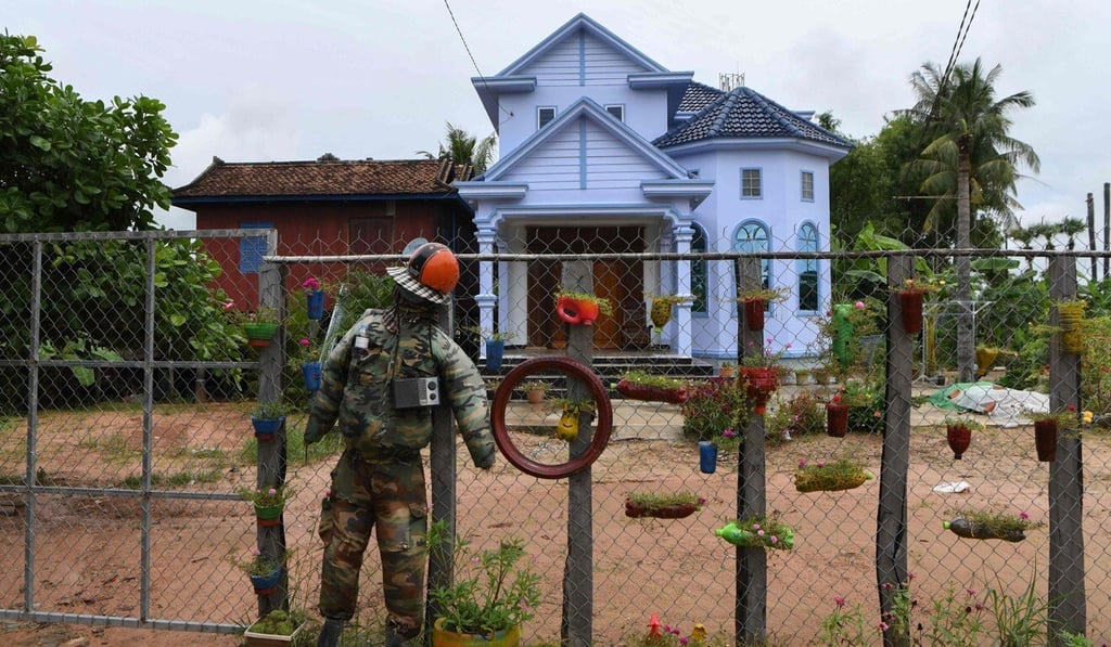 A ’Ting Mong’ is pictured tied to a fence in front of Sok Chany’s house in Cambodia's Kampong Thom province. Photo: AFP