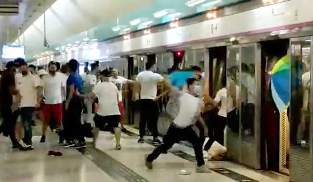 On July 21, 2019, white-clad mob indiscriminately attacking commuters and anti-government protesters with steel rods and rattan canes at Yuen Long MTR station. Photo: SCMP On July 21, 2019, white-clad mob indiscriminately attacking commuters and anti-government protesters with steel rods and rattan canes at Yuen Long MTR station. Photo: SCMP