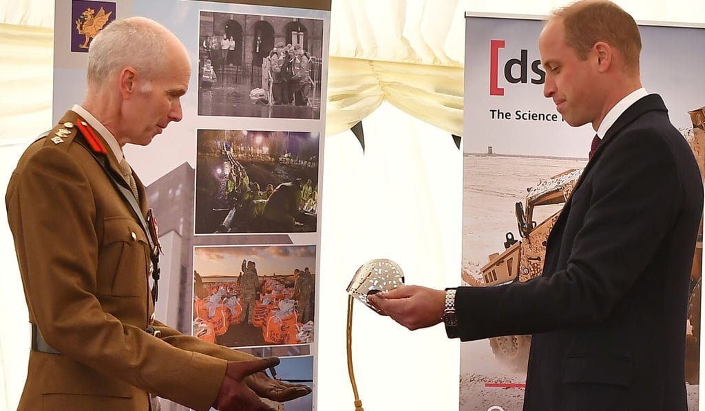 Prince William presents British Army Colonel Mike Duff on Thursday with the Firmin Sword of Peace for his department's work on the 2018 Novichok incident. Photo: Reuters