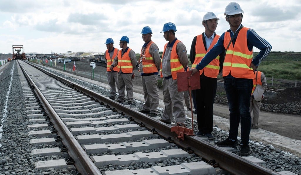 Chinese workers stand beside a rail project in Kenya in 2018. Photo: AFP Chinese workers stand beside a rail project in Kenya in 2018. Photo: AFP